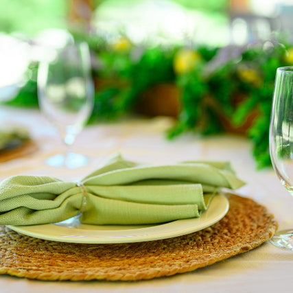 Linen & Decor RentalsTable set with green linens and glassware