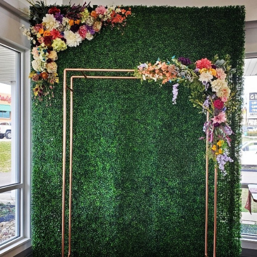 Copper wedding arch decorated with flowers