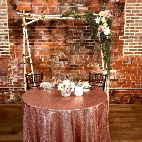 Birch tree wedding arch indoors behind a set table